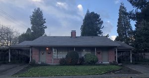 A small brick home as the sun is setting